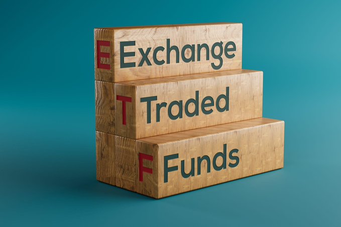The image shows a stack of wooden blocks arranged like steps, with text spelling out "Exchange Traded Funds" — each block displaying one word and a corresponding red letter (E, T, F). The staircase visual reinforces the steady accumulation described in the post, symbolizing how Bitcoin ETFs (like those from BlackRock and Fidelity) continue to build their holdings, contributing to the $101.79 million in recent BTC purchases.