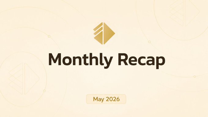 The image features a white banner with black text that reads "Monthly Recap" at the top of the banner. Below this, there are two circles with gold designs, one larger than the other. The text "May was about getting closer to the builders pushing AI x crypto forward." is written in smaller font size below the circles and above the banner.