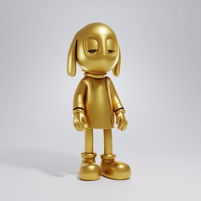A gold-colored designer art figure with large droopy eyes, long ears, and a sweater stands against a white background.