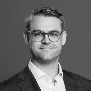 A black-and-white portrait of Bitwise CEO Hunter Horsley, who is shown smiling and wearing glasses with a suit jacket and white shirt. The image accompanies news that Bitwise's Solana Staking ETF has gained support from a major bank offering loans against it.