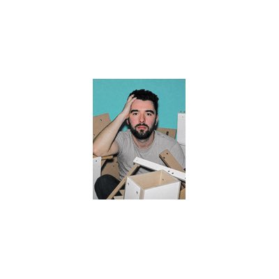 A bearded man sits amid cardboard boxes with a hand on his head, appearing stressed or overwhelmed, visually mirroring the message about wrapping up a project called "mint."