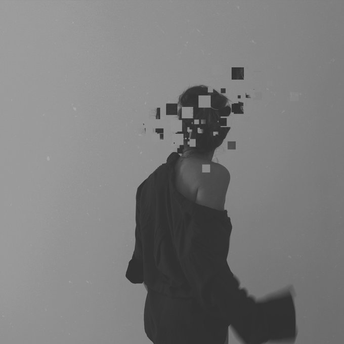 A grayscale artistic photo of a person viewed from behind wearing an off-shoulder jacket, with their face obscured by pixelated glitch effects.