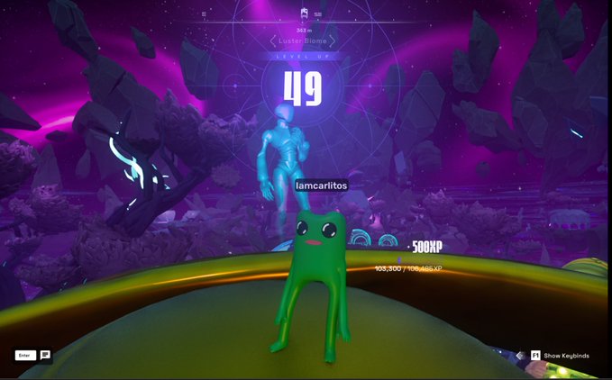 A green alien-like character stands on a platform in a vibrant purple cosmic landscape, with the text 'iamcarlitos', '-500XP', and '49' visible on screen.
