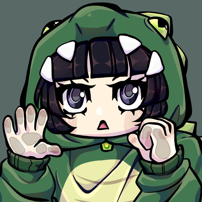 An anime-style chibi illustration of a character wearing a green dinosaur hoodie with white teeth spikes, holding their hands up in a surprised pose with large purple eyes.