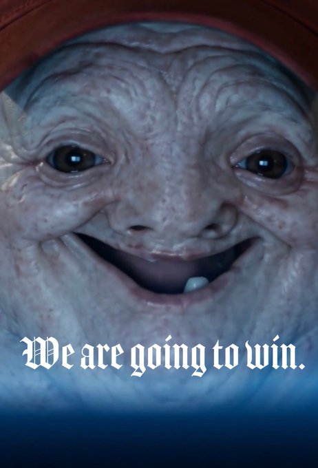 A close-up of a creepy, wrinkled face with a wide smile wearing a red hood, with the overlaid text 'We are going to win.'