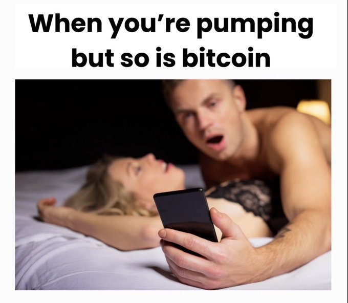 A meme captioned "When you're pumping but so is bitcoin" shows a man excitedly checking his smartphone while in bed with a woman, humorously referencing the distraction of crypto gains during an intimate moment.