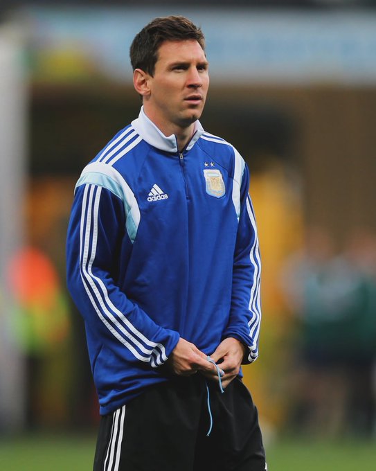 Lionel Messi wearing a blue Argentina training jacket with the Adidas logo and team crest.