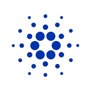 The image shows the Cardano logo, a blue circular dot pattern, representing the cryptocurrency mentioned in the news about its on-chain governance vote resulting in the cancellation of the 2026 Cardano Summit in Singapore due to the Cardano Foundation's funding request failing to secure two-thirds DRep approval.