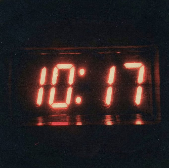 A glowing red digital clock displays the time "10:17" in the dark. The "10:17" timestamp connects to the caption "WEN APEFEST," as 10/17 (October 17th) is the likely event date being referenced.