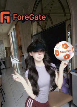 The image features a woman holding an orange and white soccer ball, with her arms raised as if she's celebrating or posing for a photo. The background of the image shows a room filled with chairs and a TV screen mounted on the wall. There is also a logo visible in the image that reads "Foregate".