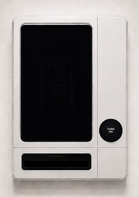 A white wall-mounted vending machine with a black front screen displaying a faint 'TUT' logo and a circular 'TURN ON' button on the right side.