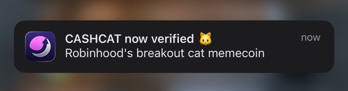 A notification banner announces "CASHCAT now verified 🐱" with the subtitle "Robinhood's breakout cat memecoin." The image supports the post "I like the fucking coin" by confirming CASHCAT's verified status, reinforcing the poster's enthusiastic endorsement of the memecoin.