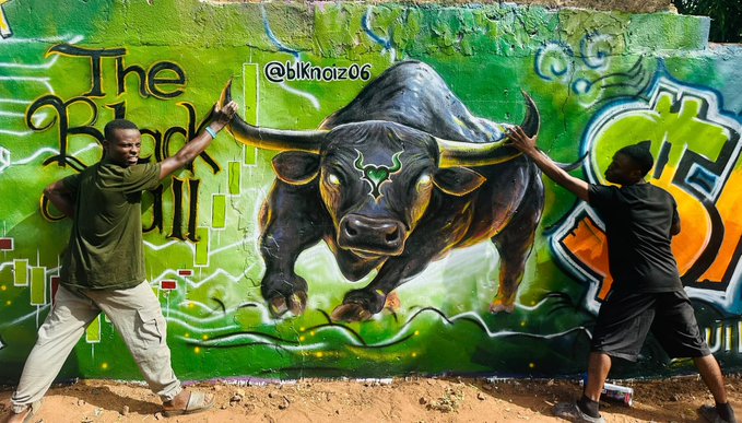 Two men pose dramatically in front of a vibrant green graffiti mural featuring a large black bull, with the text 'The Black Bull' and '@bknoiz06' visible on the wall.