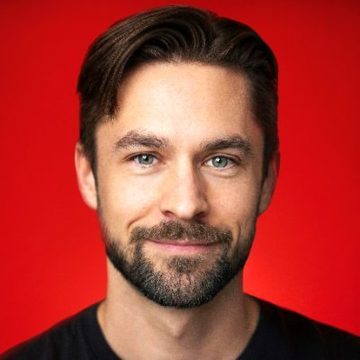 The image features a man with brown hair, wearing a black shirt against a red background. The man has a beard and mustache, giving him a distinctive look. He appears to be smiling for the camera, possibly posing for a photo or video. The caption below the image reads "Focus on what is in the image and how it relates to the post: David Hoffman's downfall - builds Bankless into one of the biggest crypto podcasts - spends years telling people Ethereum is the future - becomes one of the biggest $ETH supporters on crypto Twitter - launches a VC fund while also running a media company".