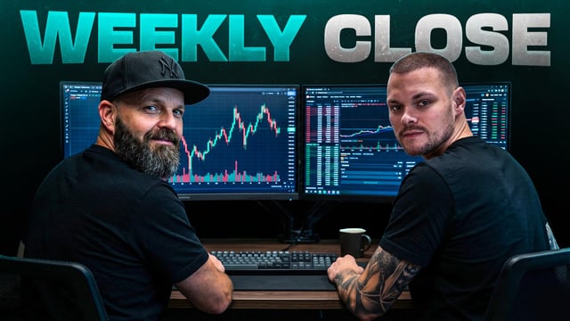 The image features two men sitting at a desk, both wearing black shirts with "Weekly Close" written on them. They are looking at computer monitors displaying stock market data, possibly analyzing Bitcoin trading setups for the upcoming Weekly Close. The presence of multiple screens suggests that they might be involved in cryptocurrency trading or have a keen interest in it.