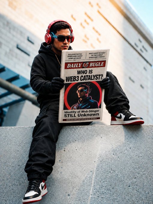 A man in dark clothing and red headphones sits on a concrete ledge reading a newspaper titled 'DAILY BUGLE' with the main headline 'WHO IS WEB3 CATALYST?'.