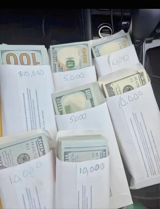 The image shows multiple envelopes containing stacks of US currency, with handwritten labels indicating amounts of "$10,000" and "5,000," displayed near a vehicle's dashboard and steering wheel start button. This appears to be a giveaway announcement post promising 2 $SOL cryptocurrency to the first 900 respondents, using the stacks of cash as a visual display of wealth to attract engagement.