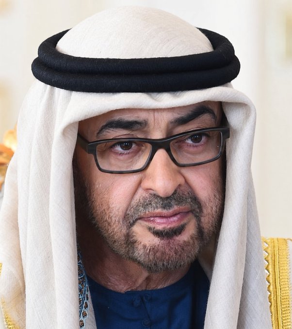 A man wearing traditional Emirati attire, including a white ghutra with a black agal, and glasses looks directly at the camera. The image likely represents a UAE official or leader, contextualizing the news about Mubadala and Abu Dhabi Investment Council's significant investment in BlackRock's Bitcoin ETF.