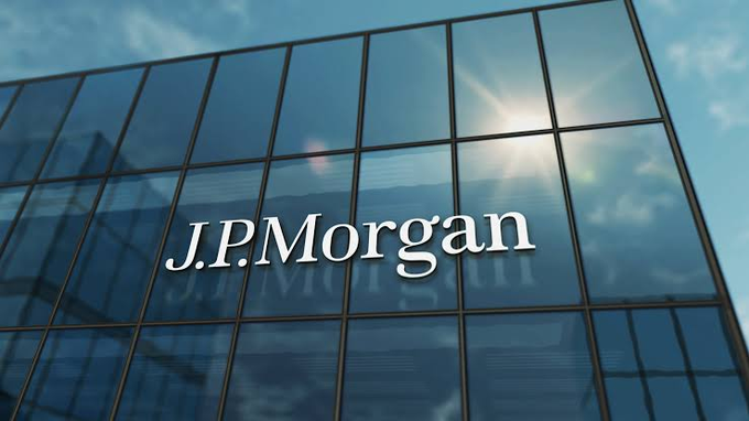 A sleek glass building facade prominently displays the "J.P.Morgan" name, symbolizing the financial institution as it expands its blockchain initiatives, including deploying JPM Coin on Ethereum's network for institutional tokenized deposit transfers and onchain collateral use.