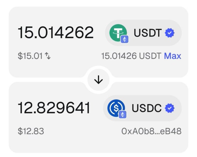 A cryptocurrency conversion screen showing 15.014262 USDT (worth $15.01) converting down to 12.829641 USDC (worth $12.83), with the USDC address starting '0xA0b8...eB48'.