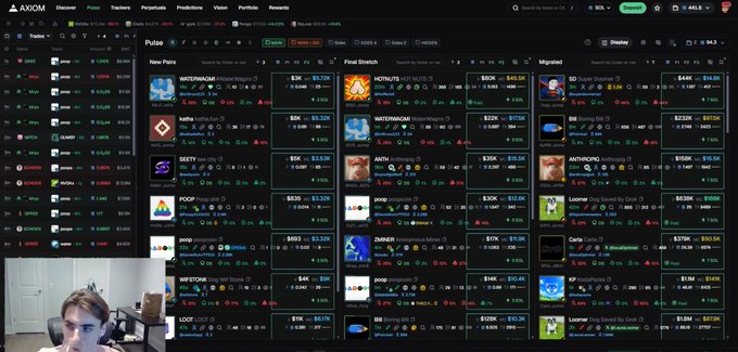 A screenshot of the AXIOM crypto tracker website showing pulse and migration sections with various tokens like WATERMARK, HOTMOM, BECK, SEETY, ANTX, POOP, ZUMBER, and CARTA, with a small webcam feed of a man in the bottom left.