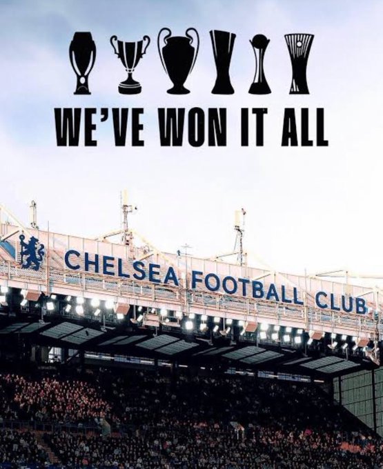 The image features an advertisement for Chelsea Football Club at a stadium filled with people watching a game. The text "We've Won It All" is displayed above the crowd of spectators, emphasizing the success of the club. The poster also includes logos for the World Cup and the UEFA Champions League, showcasing the team's achievements in various competitions.