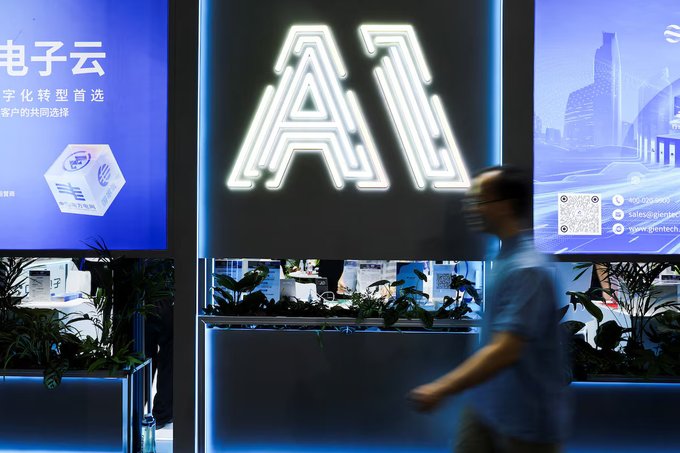 A man walks past a glowing "AI" neon sign at what appears to be a Chinese tech conference, with "电子云" (Electronic Cloud) and WeChat QR codes visible on nearby displays. The image illustrates the post's point about the AI implementation gap—the illuminated AI branding represents the widespread enthusiasm for AI initiatives, while the lone figure suggests the difficulty companies face moving from flashy pilots to actual production deployment.