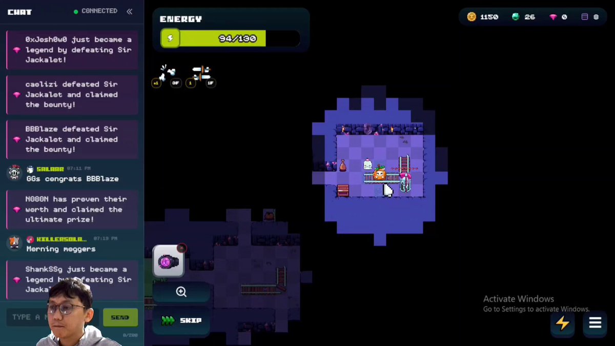 The image shows a computer screen displaying a video game interface with various elements such as a chat window, a map of a cave system, and a player's name displayed at the top left corner. The main focus of the image is on the player's name, which reads "@onchainheroes". A person can be seen in the bottom right corner of the screen, possibly interacting with the game or watching it progress.