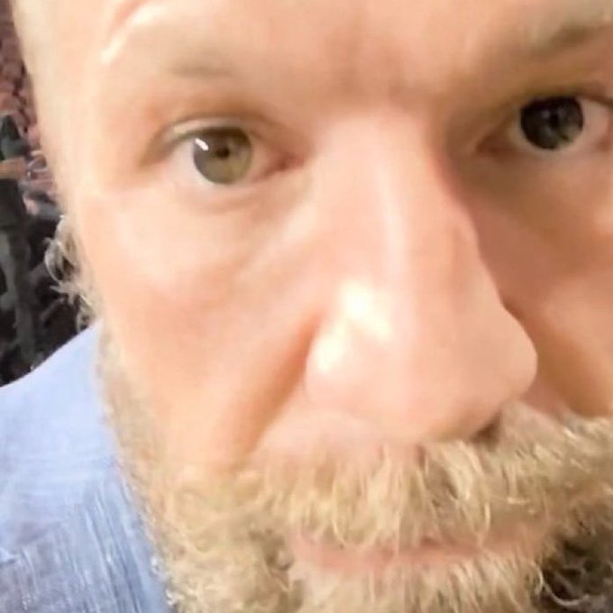 A close-up shot captures a man's furrowed brow and intense gaze directed straight into the camera, suggesting a determined or dramatic expression. The tight framing of his eyes and nose, paired with the caption about gambling on "Sweet Bonanza," humorously implies he's locking eyes with his phone as if it were his final moment before a risky bet.
