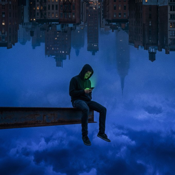 A hooded figure sits on a steel beam suspended in an inverted cityscape, illuminated by the glow of their phone screen against a twilight sky. The serene, surreal scene visually echoes the post's sentiment of "no noise up here," portraying solitude and escape from the chaos of urban life far below.
