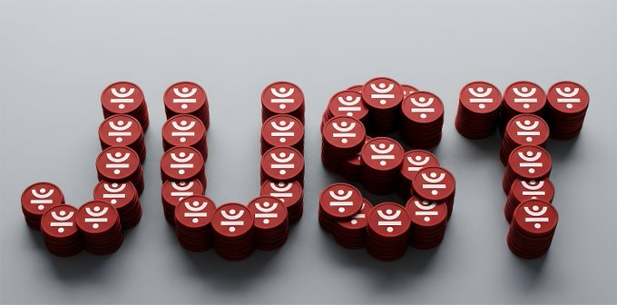 Red poker chips with a casino-style logo are arranged to spell 'JACKPOT' on a gray surface.