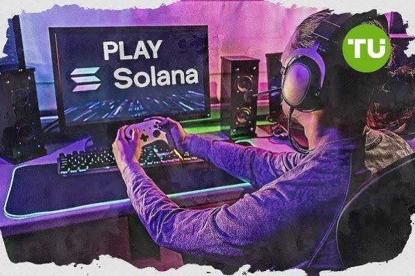 The image features a person sitting at a desk with a computer monitor displaying "Play Solana", indicating that they are playing a video game. The individual appears to be wearing headphones, suggesting an immersive gaming experience. In addition to the main subject, there is also another person partially visible in the background on the right side of the image.