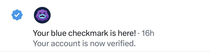 A notification stating 'Your blue checkmark is here! · 16h. Your account is now verified.' next to a purple monster avatar and a blue verification badge.