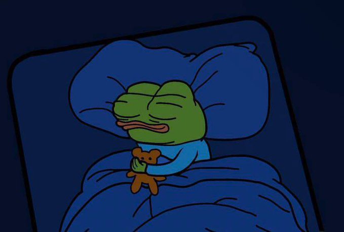 A sad Pepe the Frog cartoon character lying in bed under blue covers, clutching a small brown teddy bear in a dimly lit nighttime setting.