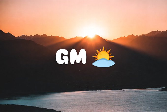 A sunrise over a mountain range with a lake below, featuring a 'GM' (Good Morning) graphic with a sun rising behind the letter 'M'.