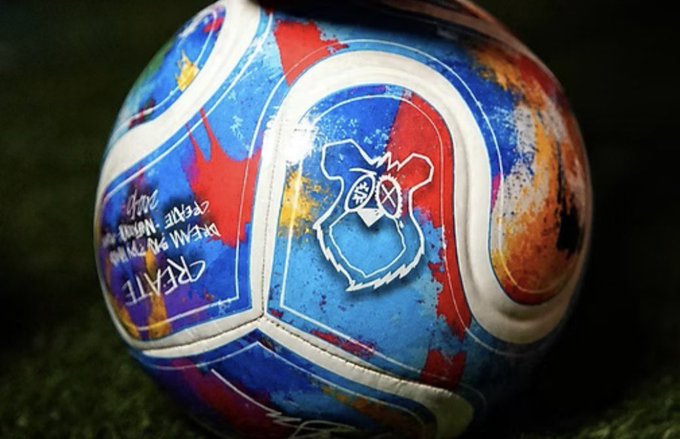 A custom-painted soccer ball with a blue, red, and white design featuring a bulldog logo and the text "CREATE - BEAT ME - I DARE YOU!" along with what appears to be a signature.