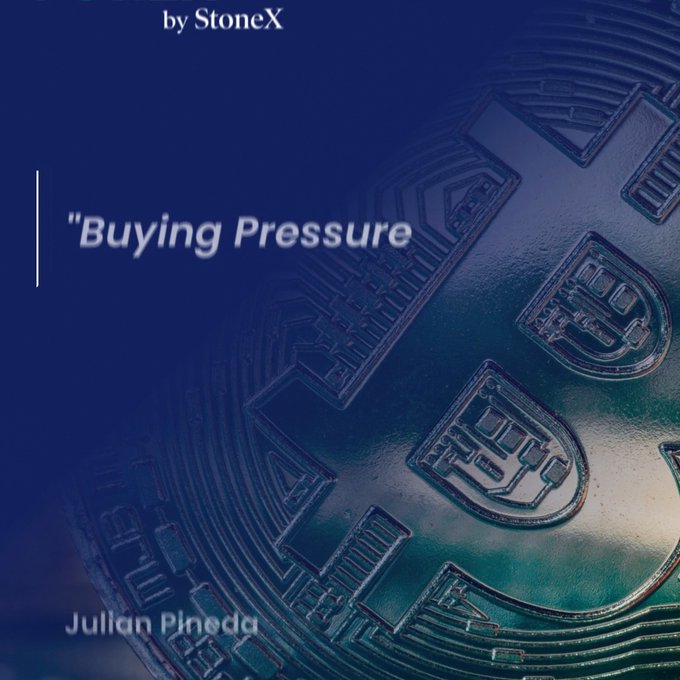 A blue-tinted close-up photograph of a Bitcoin coin overlaid with the StoneX branding, the title "Buying Pressure" by Julian Pineda, which ties into a StoneX crypto market outlook discussing technical analysis patterns, support and resistance levels, and current buying momentum in Bitcoin.