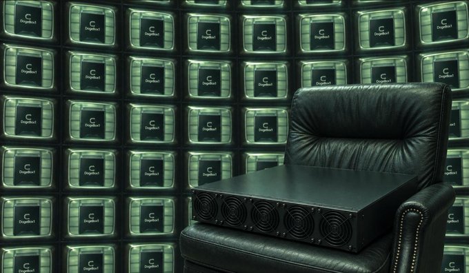 A black electronic device with multiple fans sits on a black leather chair, backed by a wall of screens displaying the 'Dogellect' logo.