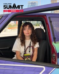 A promotional poster featuring a young woman with curly hair sitting inside a car, with the title 'A NEW DRAMA SUMMIT SERIES' displayed in the top left corner.