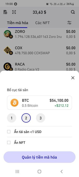 A Trust Wallet screenshot shows a suspicious 0.5 BTC balance displayed as $54,100.00, while the wallet's total assets at the top only sum to $33.63 from minor holdings like ZORO, COX, and RACA tokens. The image highlights the scam red flag mentioned in the post, where fake Bitcoin balance notifications trick users into thinking they've received crypto, despite the actual wallet value being negligible.