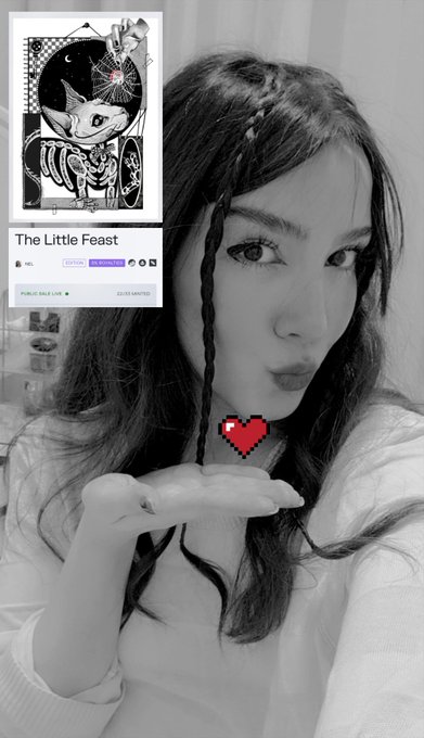 A young woman with long braided hair poses in a black-and-white photo, holding up a small pixelated red heart emoji near her face, while an inset image in the corner showcases her artwork titled "The Little Feast" — a tarot-style piece depicting a skeletal cat-like creature holding a flower. The post celebrates that 22 of 33 editions of the piece have already been collected, with only 11 remaining.