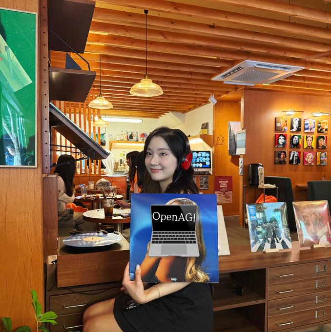 A young woman wearing red headphones sits in a cafe holding an album or book cover that displays a laptop with the text 'OpenAGI' over an image of a woman.