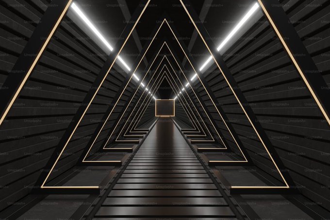 An abstract digital illustration of a triangular tunnel with glowing neon edges and overhead lights, watermarked with 'Unsplash+'.