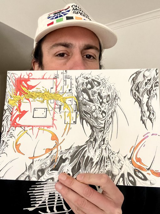 The image features a man wearing a white baseball cap holding up a drawing of a monster or a robot, which appears to be black and white. The drawing has a lot of detail and seems to be a part of an art project. The caption on the post reads "Gonna be dropping some gnarly editions in a bit on @xrpcafe Stay tuned by @DOODXRPL". This suggests that there might be more drawings or projects related to this theme, possibly involving the use of pencils and paper.
