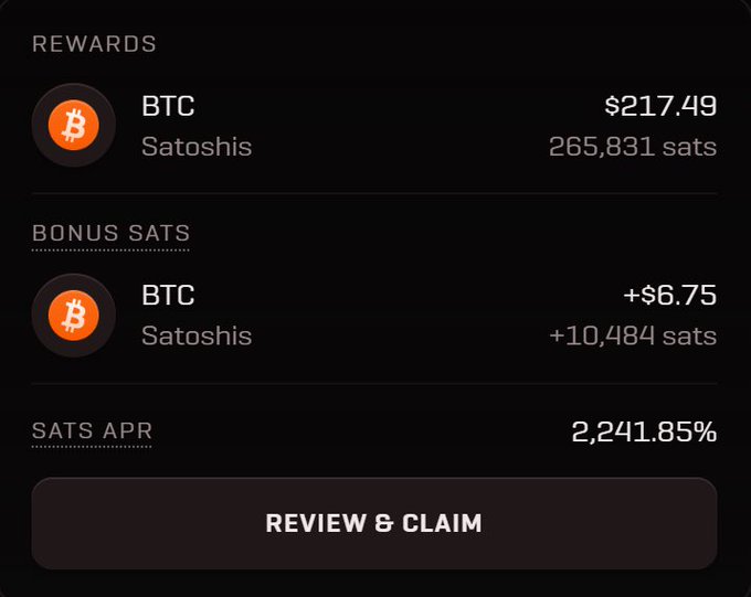 A mobile app screen showing BTC mining rewards of $217.49 (265,831 satoshis), a bonus of +$6.75 (+10,484 sats), and a 'SATS APR' of 2,241.85%, with a 'REVIEW & CLAIM' button.