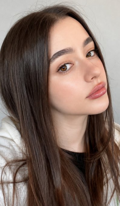 A young woman with long dark hair and glossy pink lips poses for a soft-lit selfie, complementing the affectionate "Good Night X Family" message.
