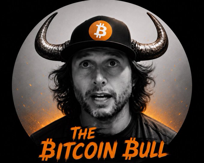 A stylized portrait of a man with long hair wearing a black cap with an orange Bitcoin symbol and large metallic bull horns, with the title "THE BITCOIN BULL" in orange text below.