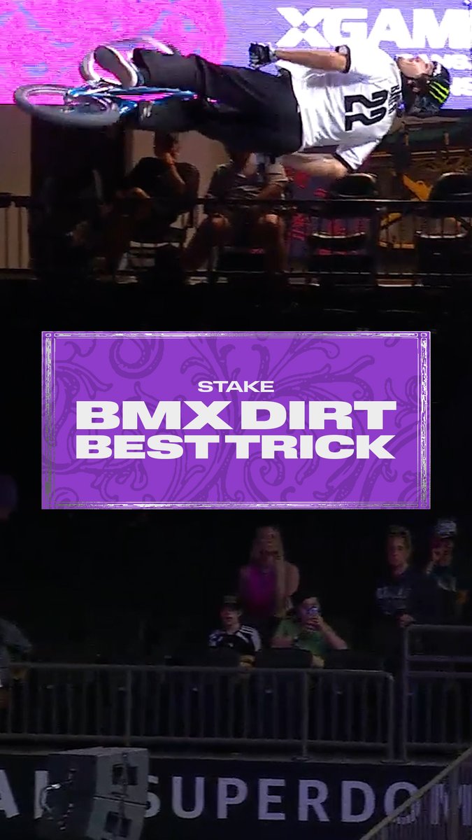A BMX rider performs an inverted aerial trick mid-flight during the "Stake BMX Dirt Best Trick" event at the X Games, with the X Games logo visible in the background. The graphic overlay announces the competition while spectators watch from the stands, capturing the action from the Moonpay X Games League Championship in New Orleans where Brady Baker earned silver.