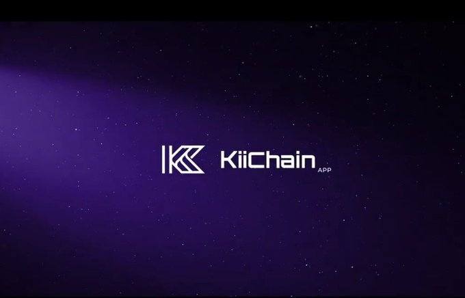 The image features a logo for a cryptocurrency called KiiChain, which is an app designed to help users manage their digital assets. The logo consists of a white "K" followed by the word "chain", indicating that this is a cryptocurrency-related application. The background of the image is purple and filled with stars, creating a sense of depth and emphasizing the vastness of space. This color scheme and design choice suggest that the app may be focused on providing users with a global financial infrastructure that can handle complex transactions across borders and time zones.