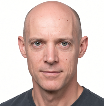 Headshot photograph of a bald man with blue eyes and a slight smile, wearing a dark t-shirt against a light gray background.